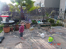 Hunter in the yard with the bubble blower.