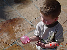 Hunter throwing water balloons